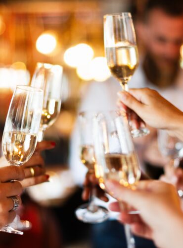 Group,Of,People,Toasting,With,Champagne,Glasses,At,A,Celebration.